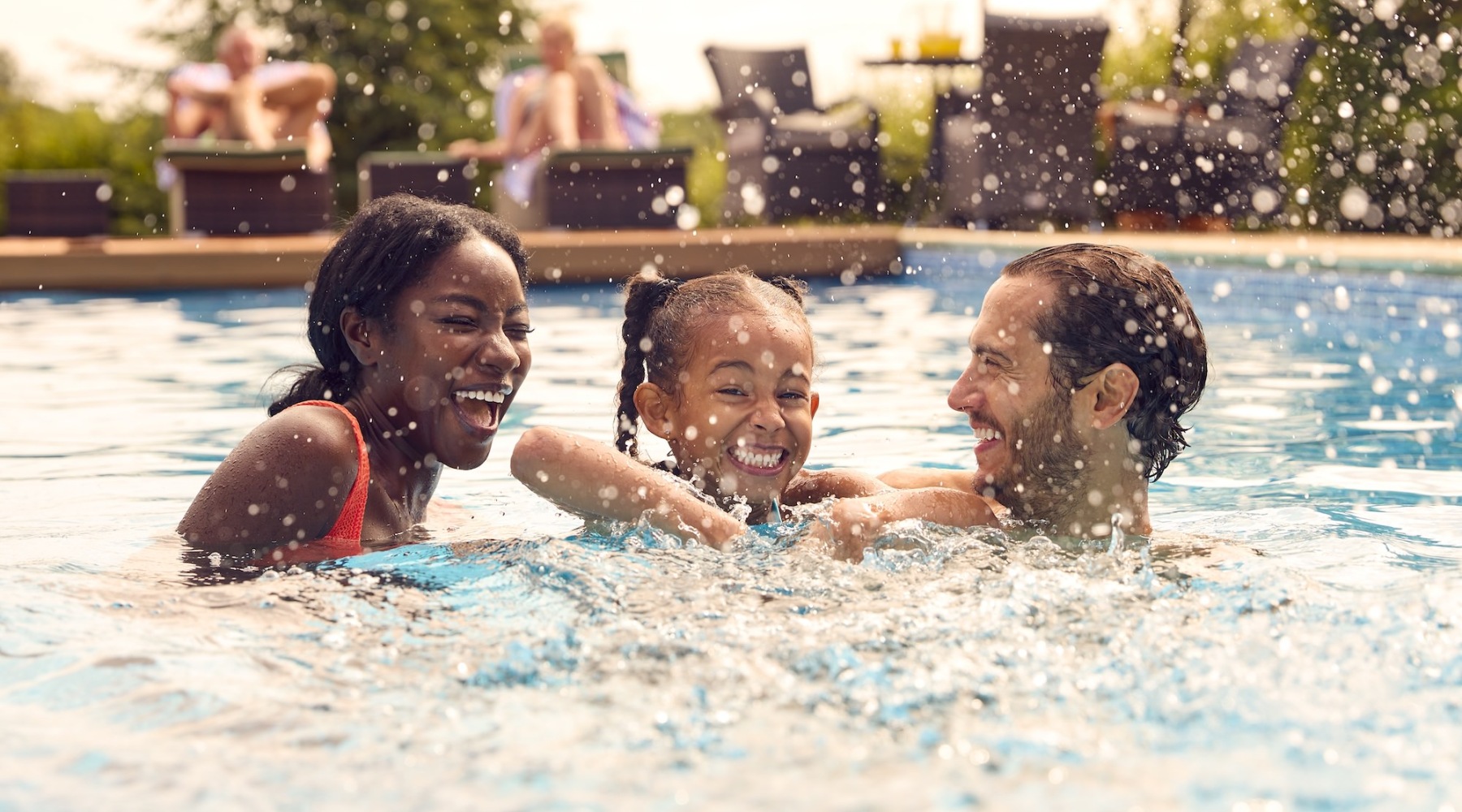 a family swimming in a pool